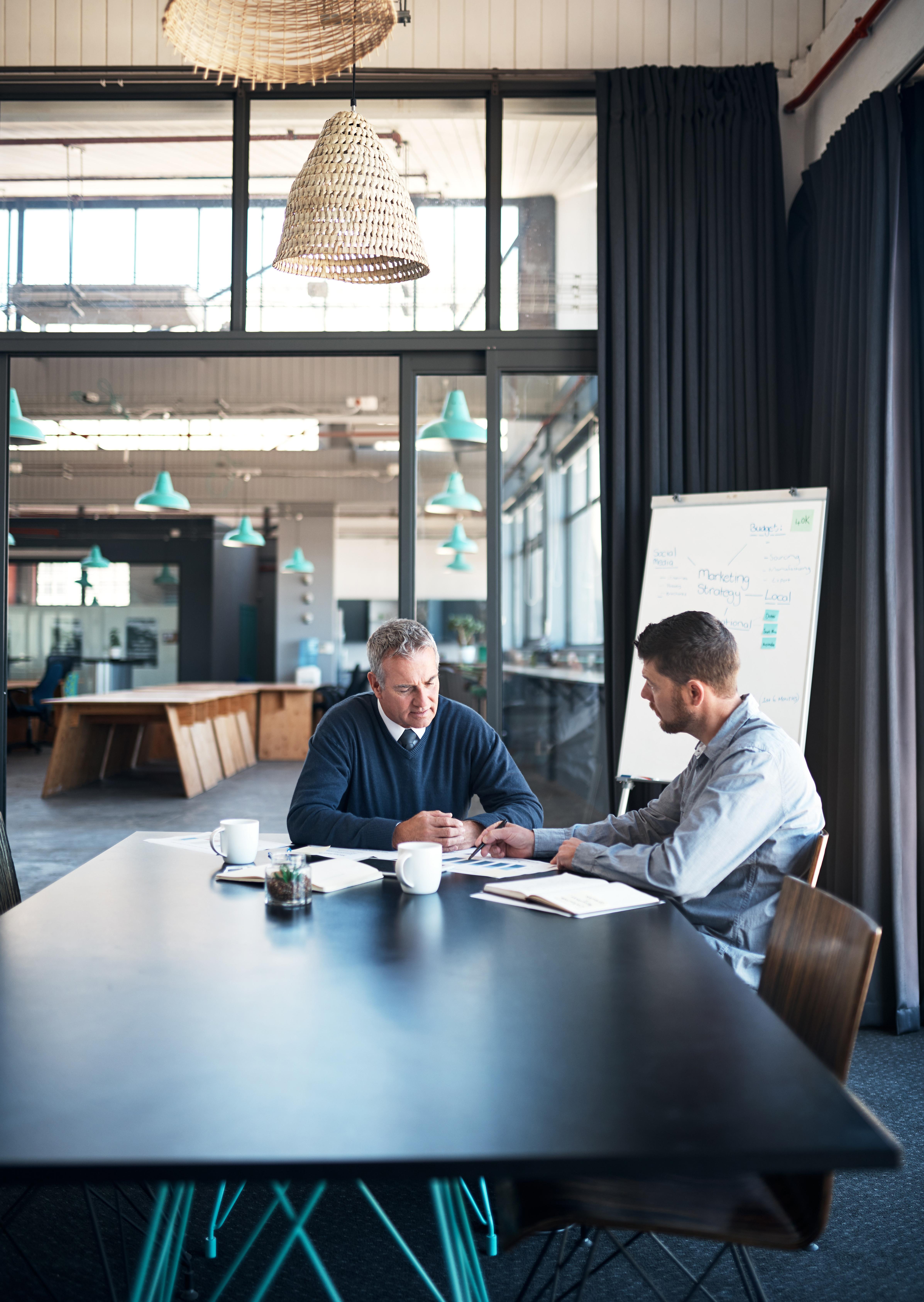 Two professionals in a one-to-one advisory conversation